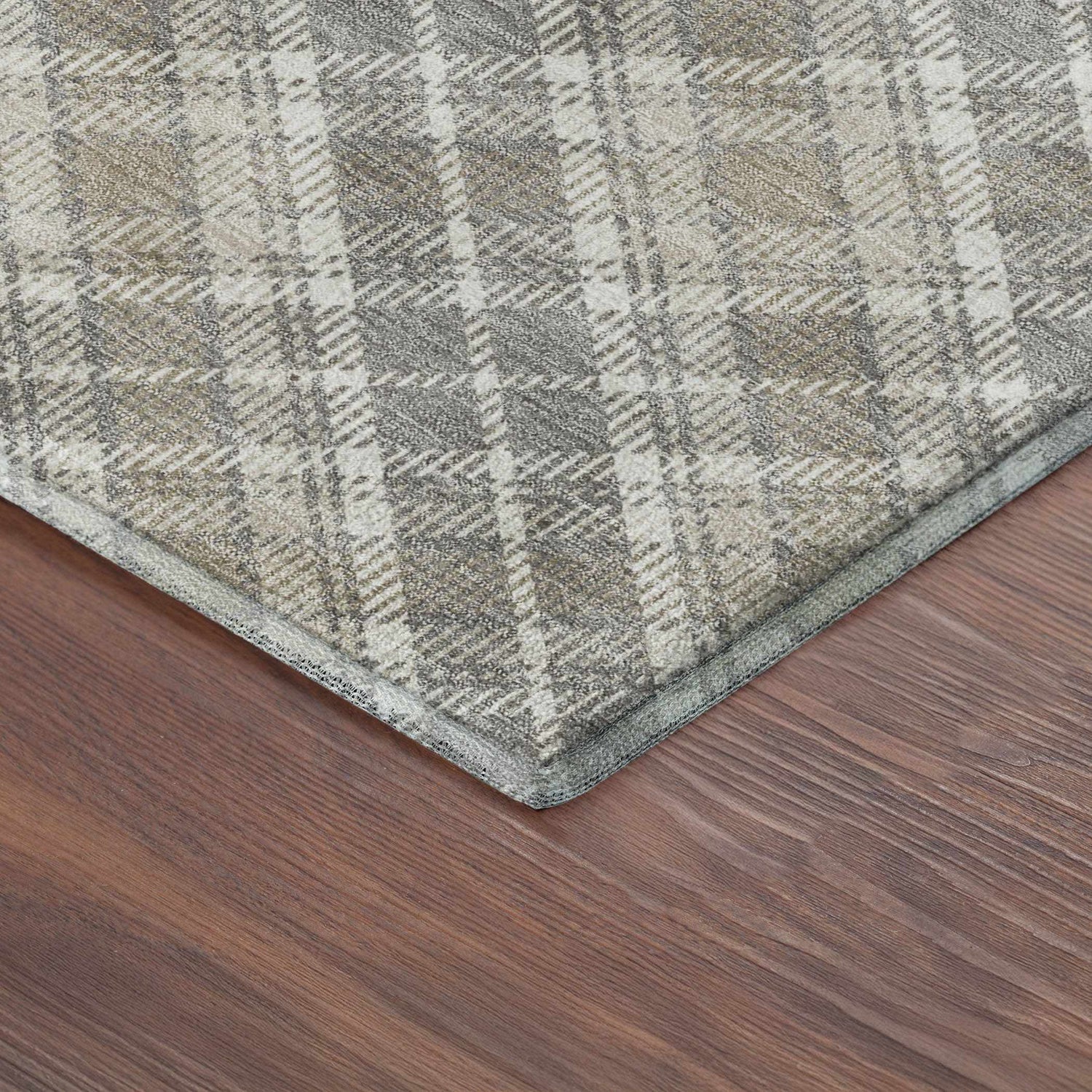 Close-up of Dalyn Luxury Soft Essentials Taupe Washable Area Rug showing ivory and taupe plaid pattern and soft texture.