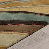 Close-up of the Seminole Area Rug showing beige, brown, teal, and burgundy stripes and wool texture. Pile