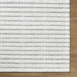 Close-up of the hand woven Laleh Cream Area Rug showing beige and cream colors with a traditional, textured pattern. Corner
