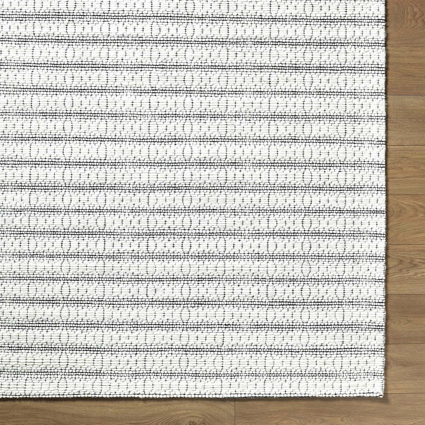 Close-up of the hand woven Laleh Cream Area Rug showing beige and cream colors with a traditional, textured pattern. Corner
