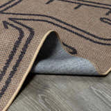 Close up of the Anuja Washable Jutely Rug showing the texture, dark brown pattern, and the light brown and gray colors. Fold