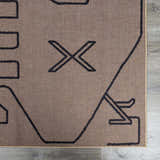 Close-up of the Hamid Washable Jutely Rug. Camel jute rug with a dark brown geometric pattern. Swatch