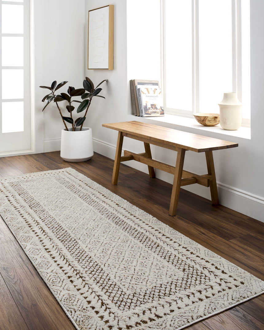 Entryway with a Julio Scandi Boho Area Rug in brown, wooden bench, and plant. Bright and airy space. Roomscene-Runner