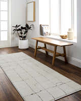 Bright entryway with a Keanu area rug, wood bench, plant, and natural light from a window. Roomscene-Runner