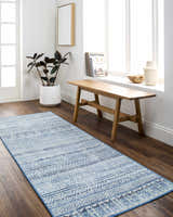 Entryway with Ianna Arctic Stone Washable Area Rug runner, wood bench, plant, and bright natural light. Farmhouse style. Roomscene-Runner