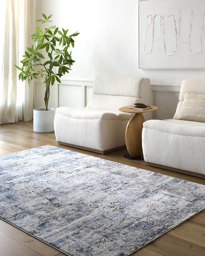 Living room scene with a blue and gray Hyman Area Rug, two white armchairs, and wood floors. Roomscene-Rectangle