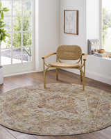 Sunlit room with Alois Tan Rich Textured Traditional Rug, woven chair, and wood floors. Roomscene-Round