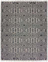 Close-up of the Skedee Area Rug. Black and cream cotton rug with a geometric diamond pattern and fringe. Hand woven. Design-Rectangle