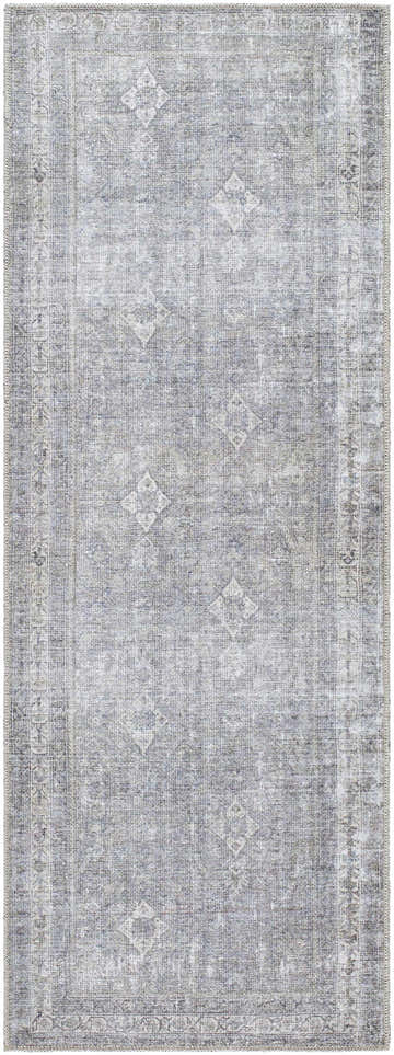 Close-up of the Kelda Washable Area Rug. Machine-woven polyester rug in gray with a faded traditional Persian-style pattern. Design-Runner-2773