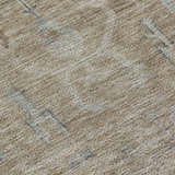 Close-up of the Dalyn Luxury Solace SL11 Tan Washable Area Rug. Beige, ivory, and silver gray tones with subtle pattern.