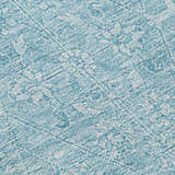 Close-up of the Dalyn Luxury Solace SL12 Sky Washable Area Rug. Features a sky blue and white farmhouse-style pattern.