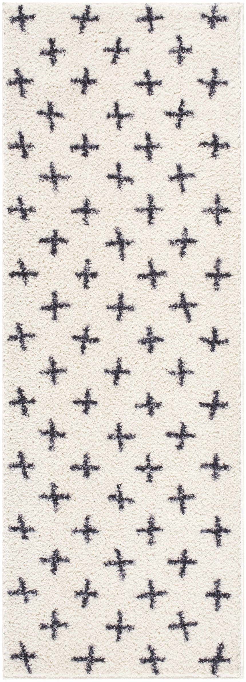 Close-up of the Bede Washable Area Rug. Beige shag rug with a charcoal plus sign geometric pattern. Contemporary style. Design-Runner-2773