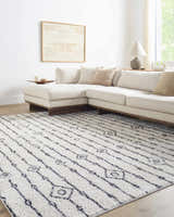 Living room scene with a Demi Beige Washable Area Rug, white sectional sofa, and neutral decor. Roomscene-Rectangle