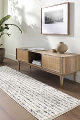 Living room scene with a Demi Beige Washable Area Rug, wood console table, art, and plant. Modern bohemian style. Roomscene-Runner