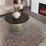 Living room scene with a bone sofa, fireplace, and rust-colored Emke Flat Pile Washable Rug with a traditional floral pattern. Roomscene-Rectangle