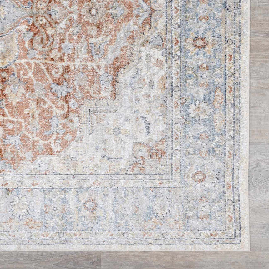 Close up of the Emke Flat Pile Washable Rug. Bone, beige, and blue traditional pattern detail. Machine woven texture. Swatch