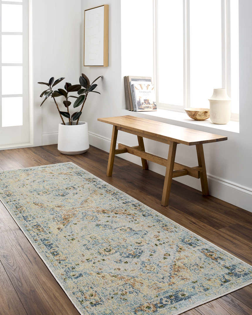 Entryway with Ezri Washable Area Rug runner in beige, light blue, and orange. Farmhouse style with wood bench and plant. Roomscene-Runner