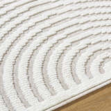 Close-up of the Deron Ivory 3D Rainbow Washable Rug. Off-white textured, curved pattern on a light gray background. Contemporary style. Texture