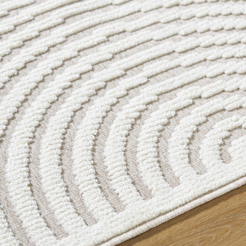 Close-up of the Deron Ivory 3D Rainbow Washable Rug. Off-white textured, curved pattern on a light gray background. Contemporary style. Texture