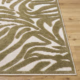 Close-up of the Keto Olive Washable Area Rug showing its off-white base and contemporary olive swirl pattern. Front