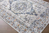 Close-up of the Paula Off White Area Rug showing its traditional charcoal, mustard, and rust colored pattern. Corner