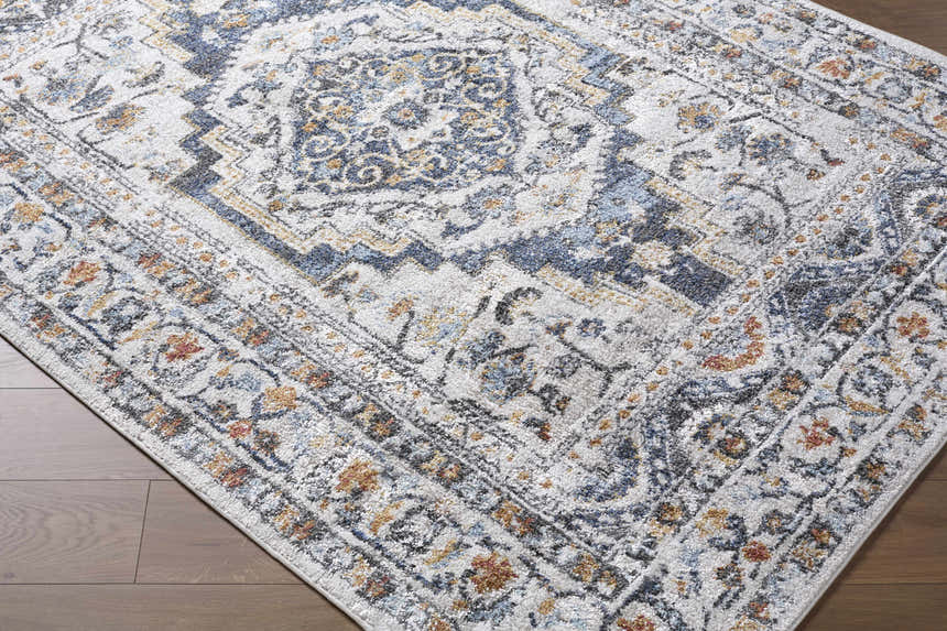 Close-up of the Paula Off White Area Rug showing its traditional charcoal, mustard, and rust colored pattern. Corner