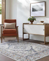 Living room scene with rust chair and Paula Off White Area Rug, featuring charcoal, brown, mustard, rust, and sage accents. Roomscene-Rectangle