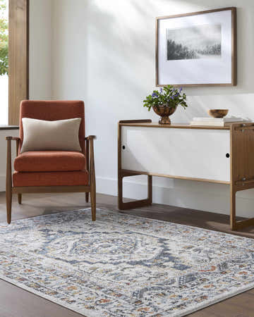 Living room scene with rust chair and Paula Off White Area Rug, featuring charcoal, brown, mustard, rust, and sage accents. Roomscene-Rectangle