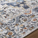 Close-up of the Paula Off White Area Rug. Features charcoal, light brown, mustard, rust, and sage colors. Texture