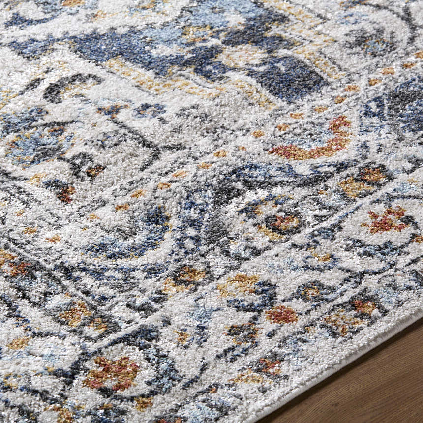 Close-up of the Paula Off White Area Rug. Features charcoal, light brown, mustard, rust, and sage colors. Texture