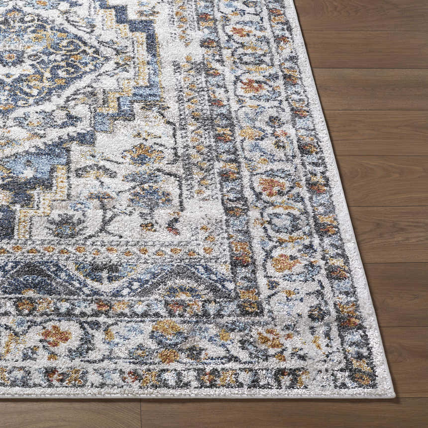 Close-up of the Paula Off White Area Rug showing its charcoal, mustard, and rust traditional pattern. Front