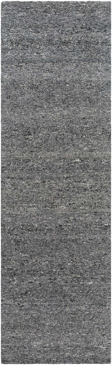 Close-up of the Sevan Charcoal Wool Area Rug, showing the gray, black, and steel gray tones and hand-tufted texture. Design-Runner-310
