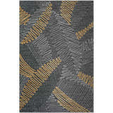 Close-up of the Dalyn Sedona SN11 Shadow Washable Area Rug. Features a black background with gold and taupe geometric pattern.