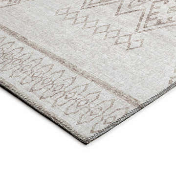 Close-up of the Dalyn Sedona SN14 Putty Washable Area Rug. Features a geometric pattern and decorative border in chestnut and ivory.
