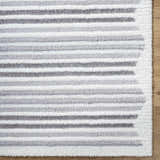 Close-up of the Buono Rose Cream Area Rug featuring a shag texture and horizontal stripes in beige and gray tones. Corner
