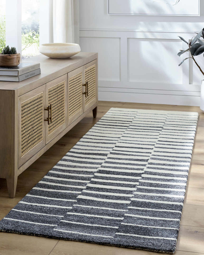 Entryway with a light wood console table and Gawel Charcoal Area Rug runner with a modern striped pattern. Roomscene-Runner