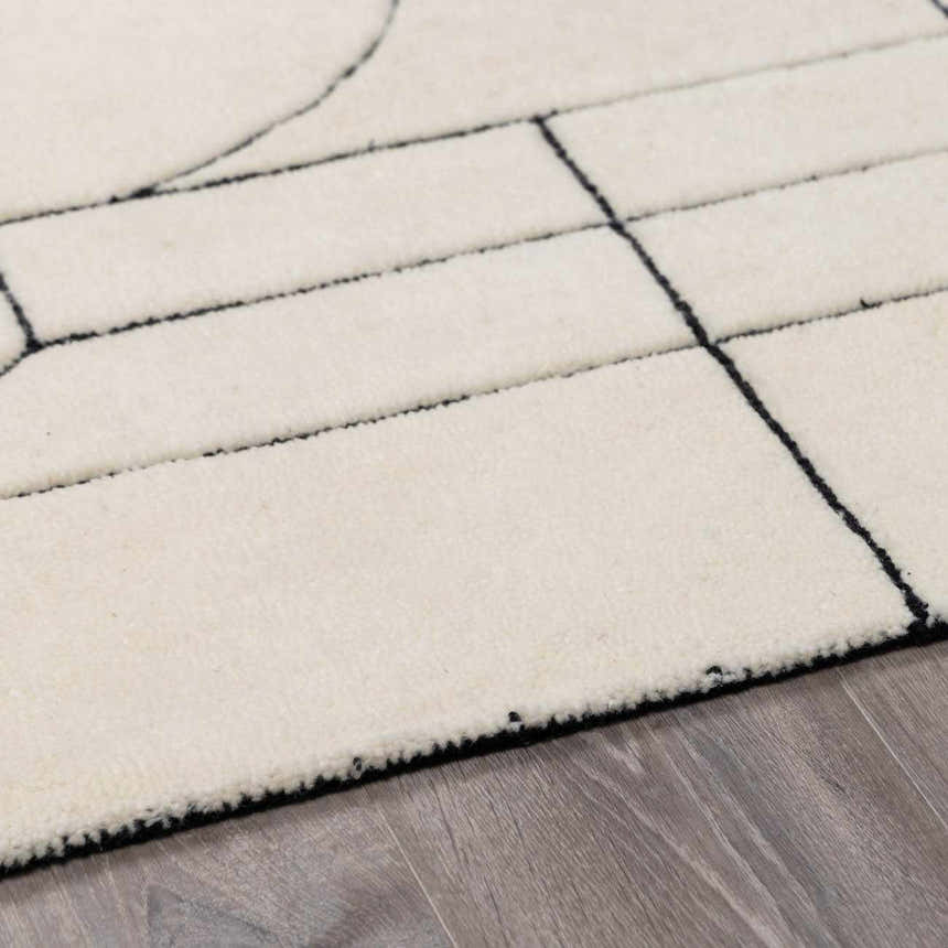 Close up of the Fusao Rose Cream Area Rug showing its beige wool texture and black geometric design. Pile
