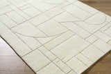 Close up of the Fusao Off White Area Rug. Contemporary design with geometric shapes and light silver accents. Corner