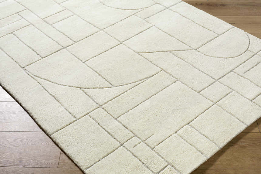 Close up of the Fusao Off White Area Rug. Contemporary design with geometric shapes and light silver accents. Corner