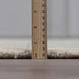 Close-up of the pile height of the Fusao Off White Area Rug, a hand-tufted wool rug. Pile