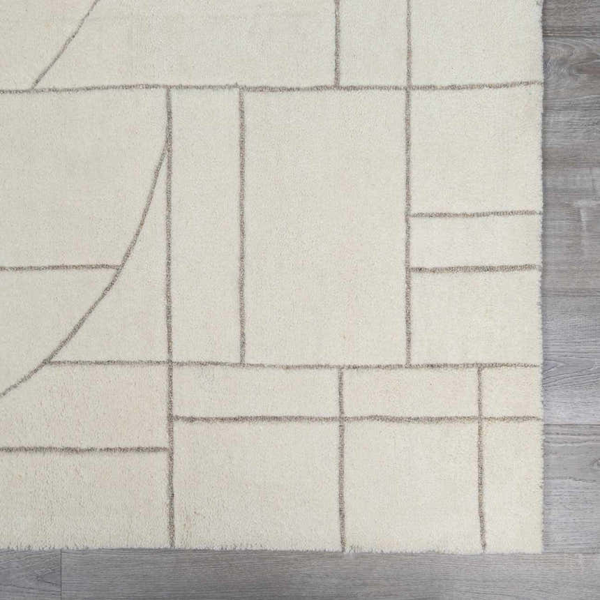 Close-up of the hand-tufted Fusao Off White Area Rug featuring a geometric light silver pattern on soft, off-white wool. Swatch