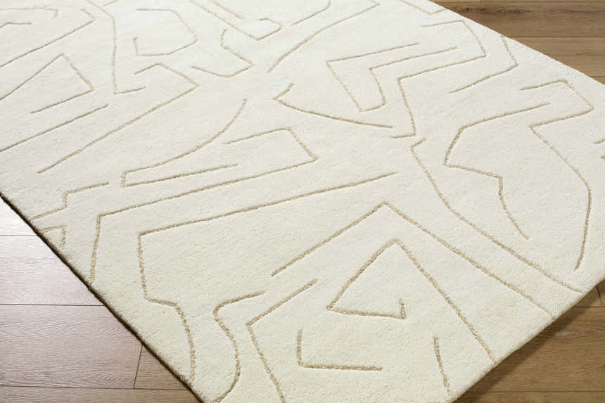 Close up of the Mony Beige Area Rug showing its hand tufted wool texture and contemporary geometric design. Corner