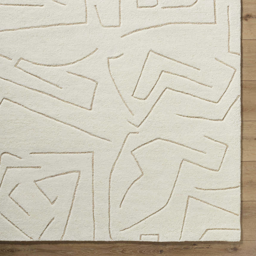 Close up of the hand-tufted Mony Beige Area Rug. Features a contemporary geometric line design and wool texture. Corner
