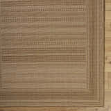 Close-up of the Freja Flatweave Faux Jute Rug. Beige and brown rug with a subtle, textured, striped pattern. Corner