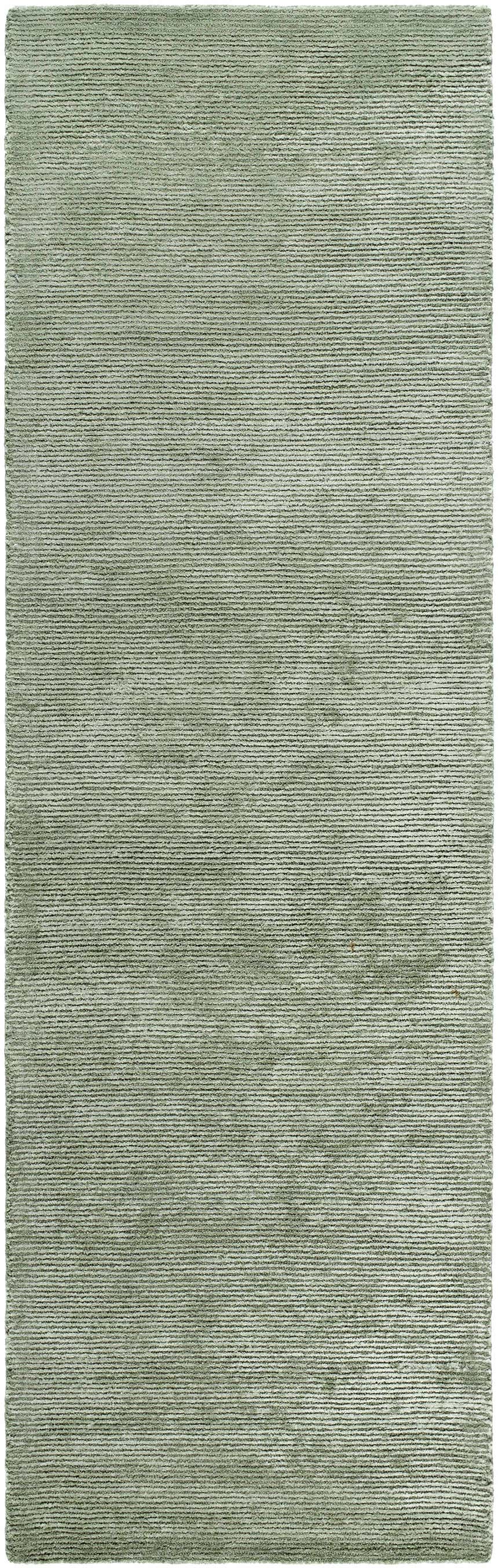 Close-up of the Helio Area Rug in sage. Hand-tufted viscose rug with a subtle horizontal stripe pattern. Design-Runner-310