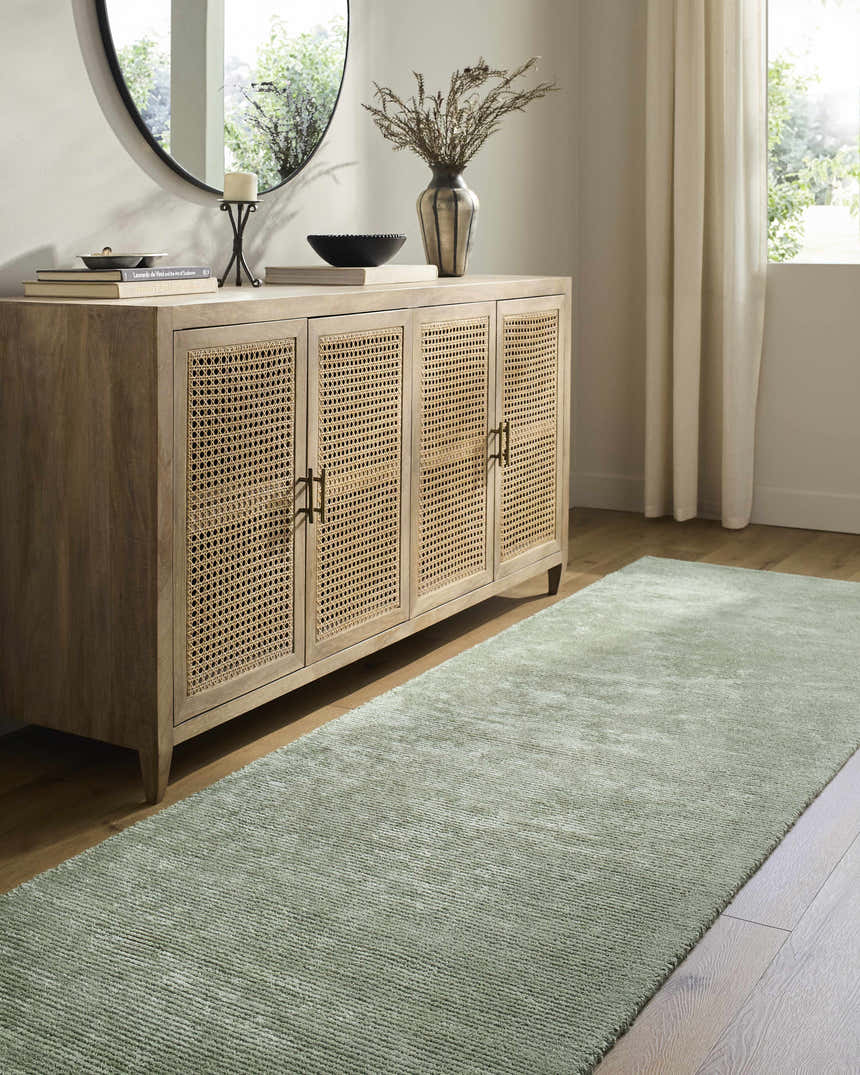 Entryway with sage Helio Area Rug, wood console table, round mirror, and natural light. Roomscene-Runner