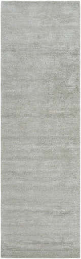 Close-up of the Makya Area Rug. Silver gray rug with a subtle horizontal striped texture. Hand-tufted viscose. Design-Runner-310