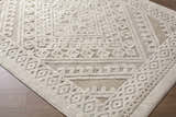 Close-up of the Hibah Bone Area Rug showing a contemporary geometric pattern in beige and bone on a wood floor. Corner
