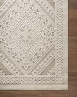 Close-up of the Hibah Bone Area Rug showcasing its beige geometric design and textured, machine-woven construction. Corner