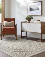 Living room scene with a Hibah Bone Area Rug, orange chair, and mid-century modern cabinet. Roomscene-Rectangle